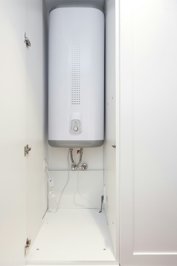 Electric storage hot water system installed in a cupboard